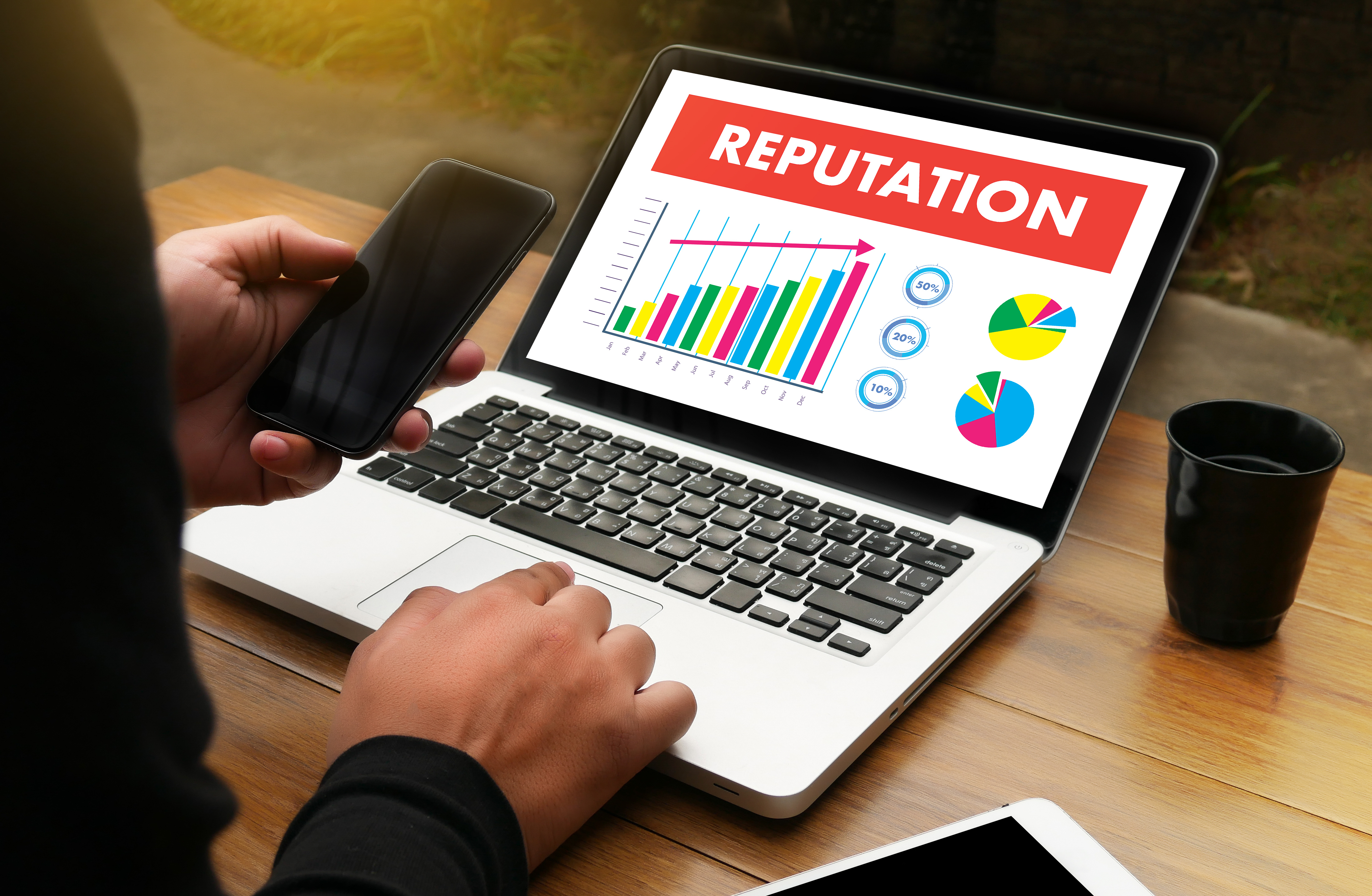 Image of a laptop that is displaying a chart that monitors reputation